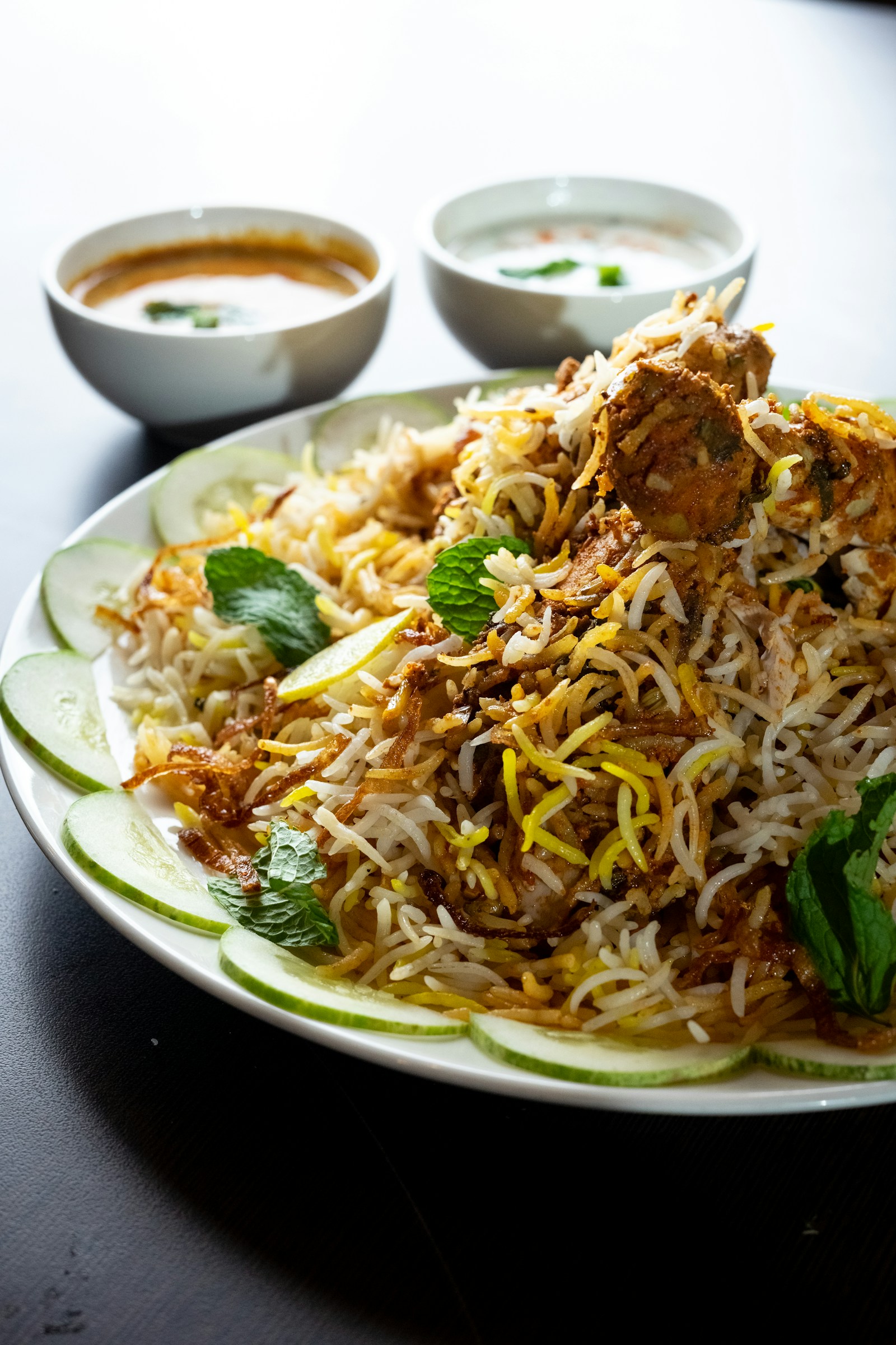 Ba-zauq catering hero with Mughlai mutton biryani feast and Melbourne skyline background